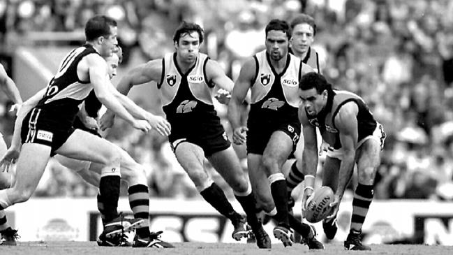 Essendon’s Michael Long (far right) seemingly taking on the entire West Coast side in this 1995 game. Longy’s explosive foot speed and extraordinary evasive skills could split open opposition defences at will. Picture: Ross Swanborough