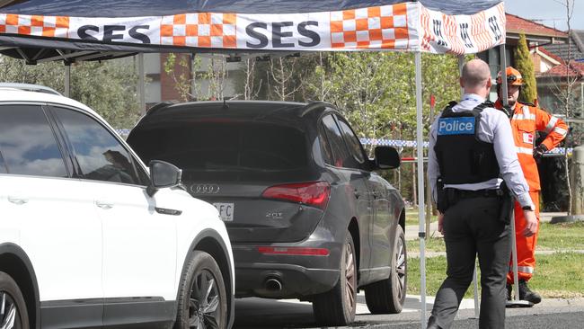 Police keep watch on an Audi Q5 in a nearby street.