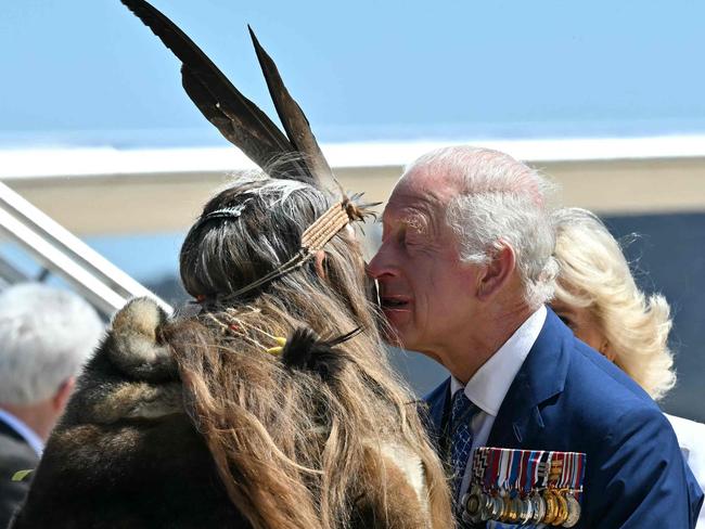 Britain's King Charles III and Queen Camilla are greeted by Ngunnawal Elder Aunty Serena Williams (2nd L) at Defence Establishment Fairbairn in Canberra on October 21, 2024, during a six-day royal visit to Sydney and Canberra. (Photo by Saeed KHAN / POOL / AFP)