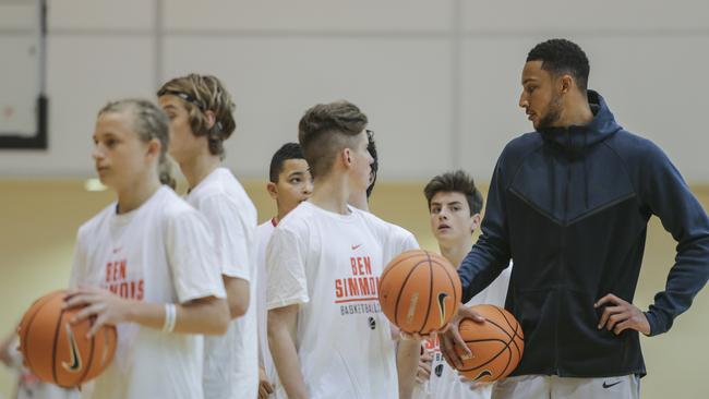 Ben Simmons exchanges a word of advice with some budding hoops stars. Picture: Wayne Taylor.