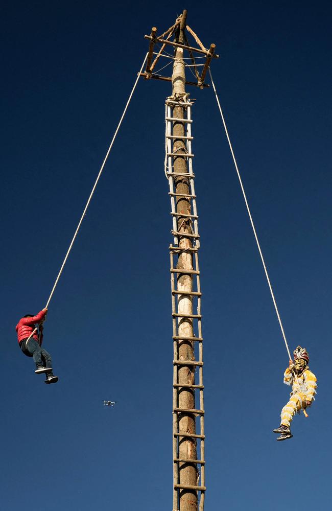 Indigenous men perform on a 30m flying pole to thank for the crops and welcome the winter solstice in a Guatemalan tradition. Picture: Emmanuel Andres/AFP