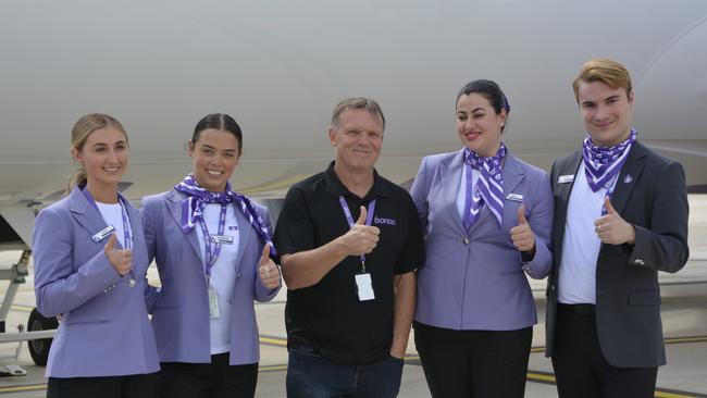 Bonza CEO Tim Jordan (centre) with members of the cabin crew at the first flight by the carrier from Melbourne to Toowoomba Wellcamp Airport.