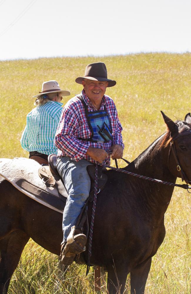 Head drover Bruce Tye remains cheerful despite a slipping saddle pad.