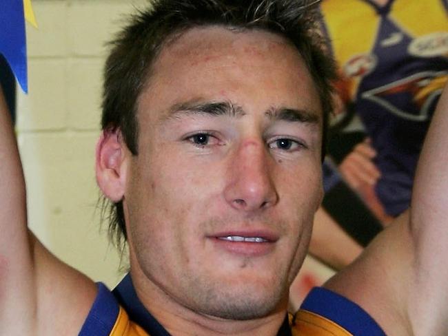 MELBOURNE, AUSTRALIA - SEPTEMBER 30: Adam Hunter of the Eagles lifts the trophy in the rooms after the AFL Grand Final match between the Sydney Swans and the West Coast Eagles at the Melbourne Cricket Ground on September 30, 2006 in Melbourne, Australia. (Photo by Mark Dadswell/Getty Images)