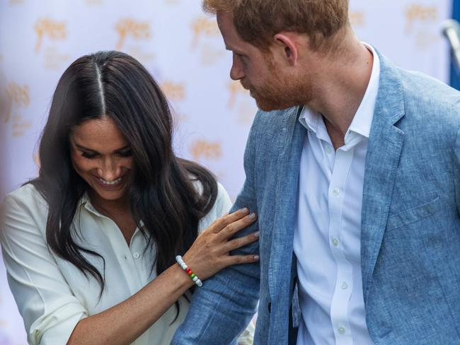 Harry was particularly protective of Meghan during a visit to the Youth Employment Services Hub in Tembisa township, Johannesburg. Picture: Michele Spatari/AFP