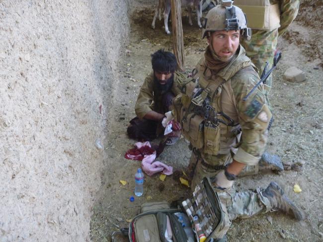 Corporal Tom Newkirk treats an injured civilian. Picture: Supplied