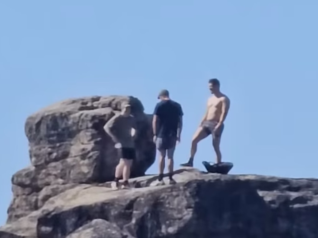 The men were seen standing on top of White Rock. Picture: Facebook