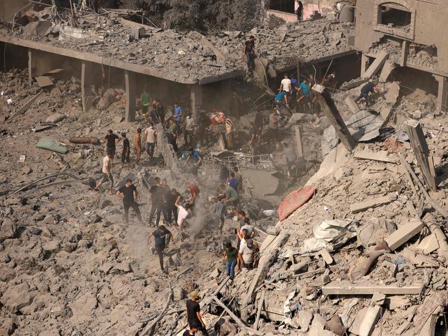 People check buildings destroyed in an Israeli strike on the Bureij refugee camp in the central Gaza Strip. Picture: AFP