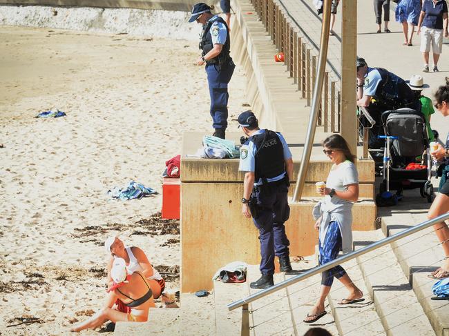 Police check on beachgoers on April 24, 2020, as social distancing regulations continue at Dee Why Beach. Picture: Jeremy Piper.