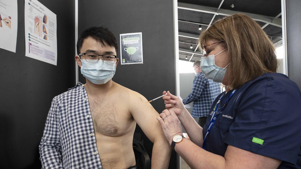 Mass vaccination clinic at MAC 02 Hobart, Mercury journalist Kenji Sato receives his vaccination from enrolled nurse Ann Richardson. Picture: Chris Kidd