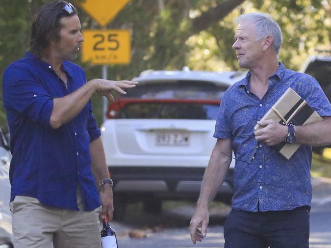 Tennis great Pat Rafter and Craig Hemsworth turn up with wine and a present. Picture: Media Mode