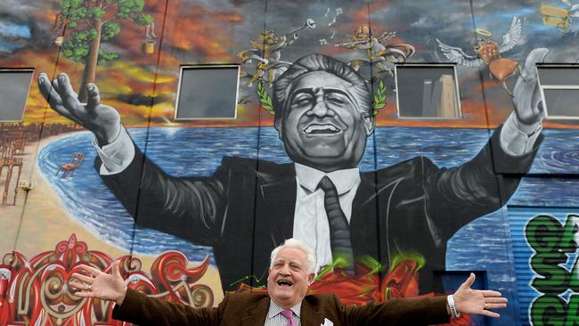 Franco Cozzo with art work of himself on the side of his building in Footscray. Picture: David Smith