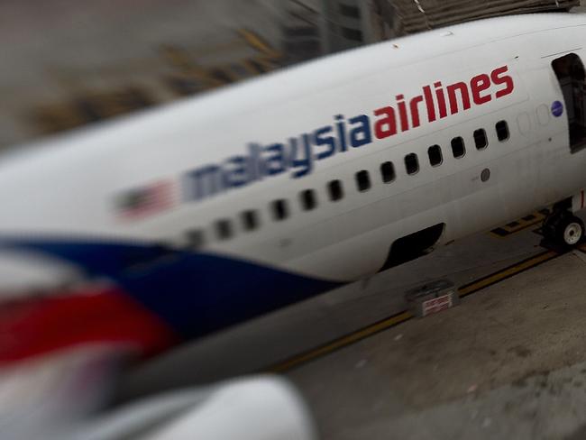 (FILES) This file photo taken with a tilt and shift lens on June 16, 2014 shows a Malaysia Airlines plane parked on the tarmac at Kuala Lumpur International Airport in Sepang. The official search for MH370 may have been called off but experts believe the missing airliner will one day be found, perhaps either by deep-sea miners or treasure hunters lured by a huge cash reward. After spending almost three years and 150 million USD on a deep sea hunt for the Malaysian passenger jet in the remote Indian Ocean off western Australia, top aviation investigators have been forced to admit they have come up with nothing.  / AFP PHOTO / MANAN VATSYAYANA / TO GO WITH Australia-Malaysia-China-MH370-aviation,FOCUS by Glenda KWEK