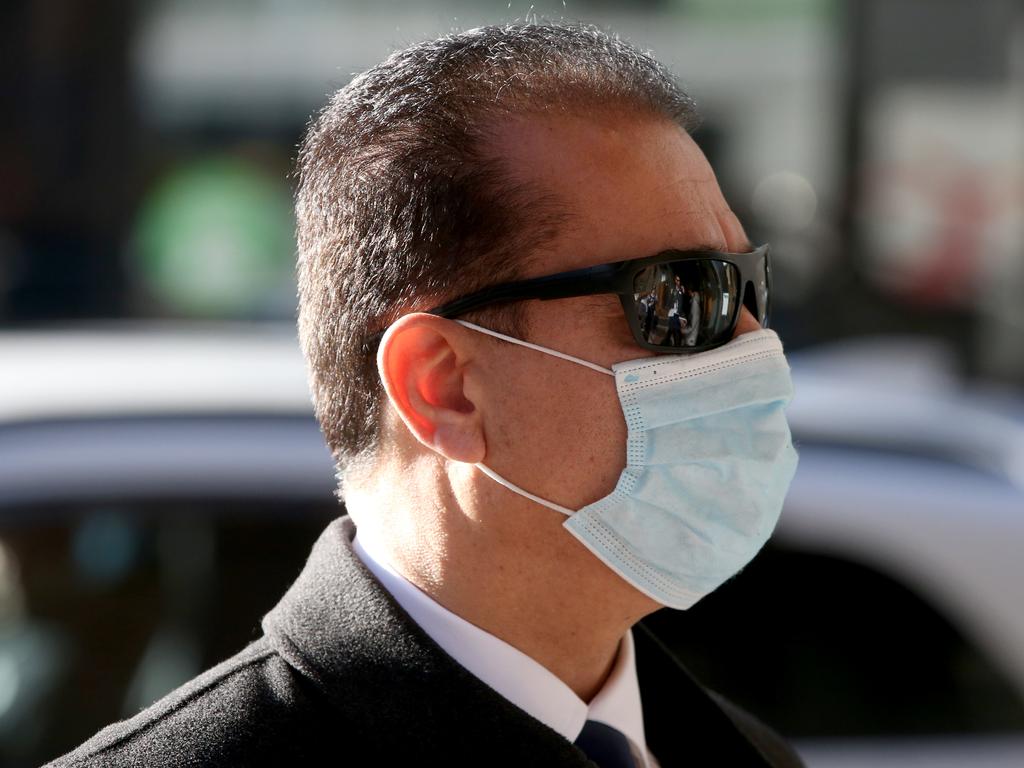 Ali Khorami wears a mask while walking towards the Downing Centre courts in Sydney. Picture: NCA NewsWire/Damian Shaw