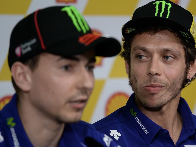 Valentino Rossi of Italy (R) looks on as teammate Jorge Lorenzo (L) of Spain addresses a press conference.