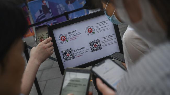 In China, QR codes are used to gain entry to businesses. (Photo by Kevin Frayer/Getty Images)