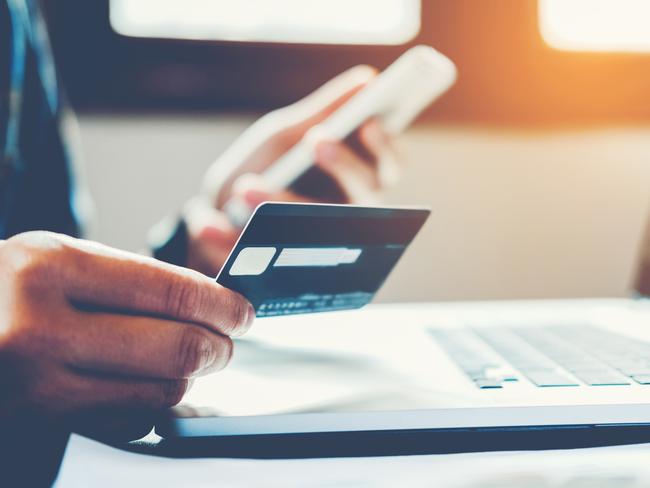 Man Holding Credit Card And Using Cell Phone holding credit card with shopping online