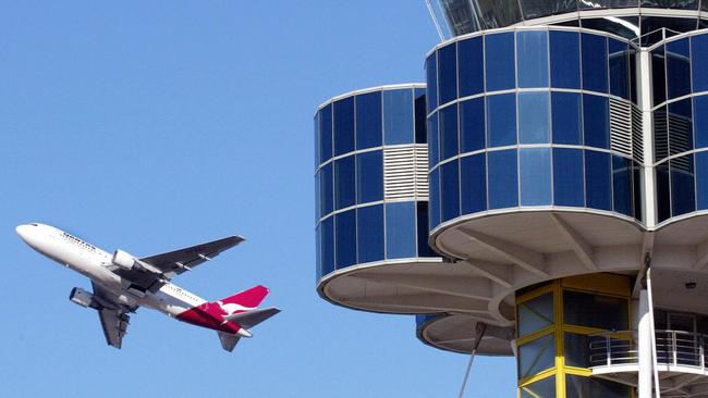 AUGUST 28, 2002 ; A file photo dated 28/08/02 shows a Qantas jet as it flies past the control tower at Sydney Airport, 28/08/02.NSW / Aviation / Aircraft / Plane / Exterior