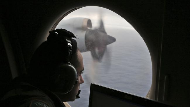 Flight officer Rayan Gharazeddine scans the water in the southern Indian Ocean off Australia from a Royal Australian Air Force AP-3C Orion during a search for the missing Malaysia Airlines Flight MH370.