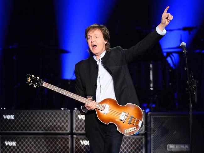 (FILES) This file photo taken on May 30, 2016 shows British musician and former Beatles' member Paul McCartney  performs on stage at the Bercy stadium in Paris. Paul McCartney has kept a packed touring schedule in recent years but the 74-year-old Beatles legend says he may need to slow down soon. Asked by Rolling Stone magazine if he could imagine touring in the same way at 80, McCartney replied: "Unimaginable -- and unseemly." But McCartney added that, when he was 17, he thought a 24-year-old at fellow Beatle John Lennon's art school was old. "People say age is a number. It's a big number the older you get," he said in the interview published August 10, 2016.  / AFP PHOTO / BERTRAND GUAY