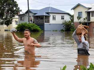 Residents wade through rising floodwaters as they leave their home in central Lismore, New South Wales, Friday, March 31, 2017. The Wilsons River breached its banks early morning flooding the far-northern NSW town. (AAP Image/Dave Hunt) NO ARCHIVING. Picture: DAVE HUNT