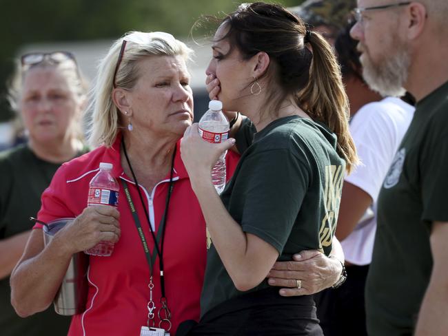 Santa Fe High School staff were emotional as they gathered in petrol station car park after the shooting. Picture: Jennifer Reynolds/The Galveston County Daily News via AP