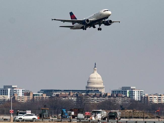 ARLINGTON, VIRGINIA - JANUARY 30: A plane takes off from Reagan National Airport after the crash last night of an American Airlines plane on the Potomac River as it approached the airport on January 30, 2025 in Arlington, Virginia. The American Airlines flight from Wichita, Kansas collided midair with a military Black Hawk helicopter while on approach to Ronald Reagan Washington National Airport. According to reports, there were no survivors among the 67 people on both aircraft.   Al Drago/Getty Images/AFP (Photo by Al Drago / GETTY IMAGES NORTH AMERICA / Getty Images via AFP)