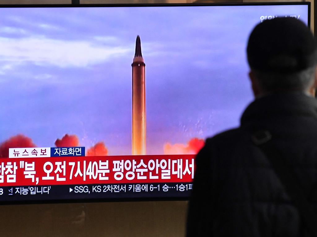 A man watches a television screen showing a news broadcast with file footage of a North Korean missile test, at a railway station in Seoul. Picture: Jung Yeon-je / AFP