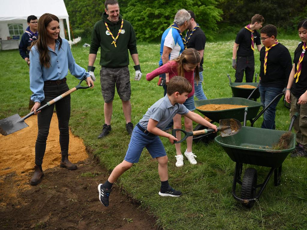 Catherine, Princess of Wales, Prince Louis and Princess Charlotte help to reset a path while taking part in the Big Help Out. Picture: AFP