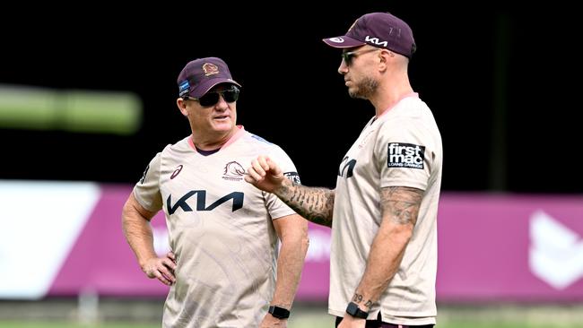 Darius Boyd chats with Broncos coach Kevin Walters.