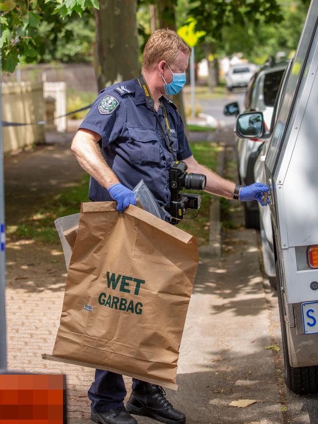 Police remove evidence from the bag. Picture: Ben Clark