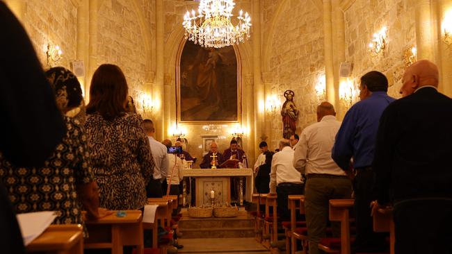 Palestinian christians attend mass for those killed during a strike on the Greek Orthodox church of Saint Porphyrius in Gaza City on October 20, in the village of Jifna, north of Ramallah in the occupied West Bank. Picture: Jaafar ASHTIYEH / AFP