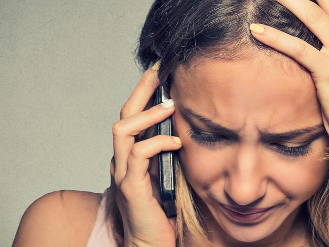 Portrait unhappy young woman talking on mobile phone looking down. Human face expression, emotion, bad news reaction.