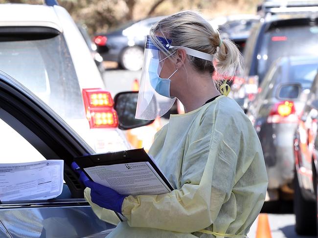 PERTH, AUSTRALIA - MAY 03: A health worker carries out COVID-19 testing at the Joondalup drive-through clinic on May 03, 2021 in Perth, Australia. Perth is on alert after a hotel quarantine security guard from the Pan Pacific hotel and two of his housemates tested positive for COVID-19 on the weekend. While WA Premier Mark McGowan has not imposed a lockdown in response to the recent cases, restrictions requiring the use of face masks outdoors have been reintroduced. (Photo by Paul Kane/Getty Images)