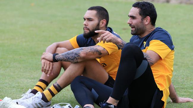 Jarman Impey and Shaun Burgoyne watch some younger Hawks go through their paces. Picture: Mark Stewart