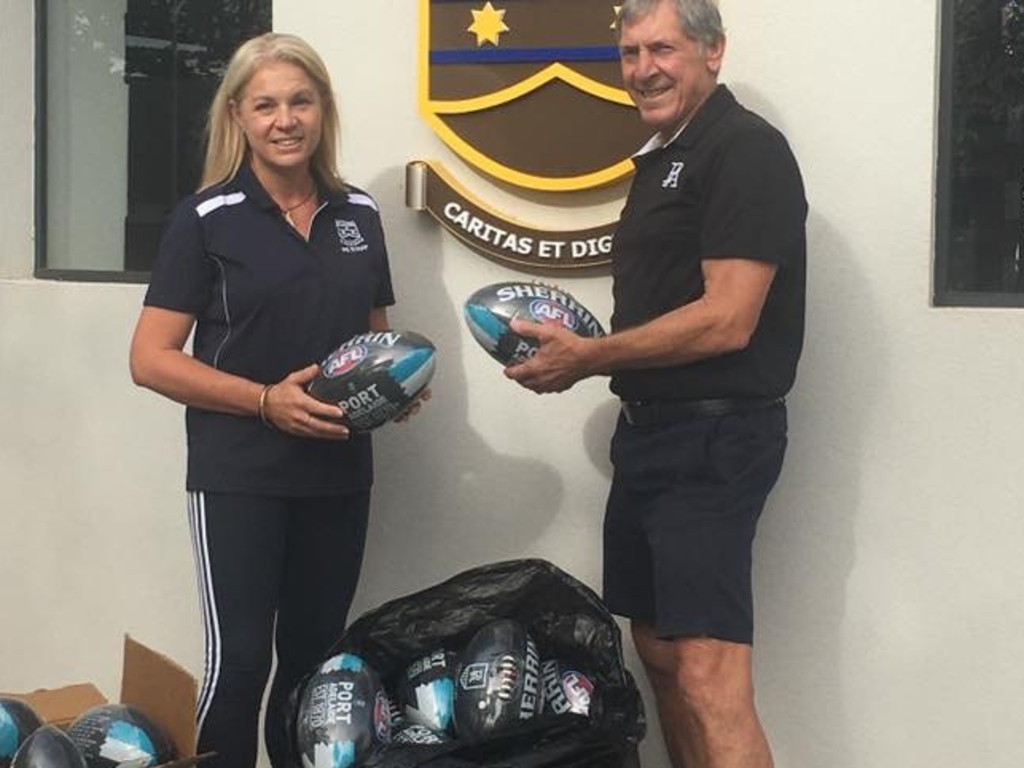 Mt Carmel College received 40 footballs from the Port Adelaide Power Football Club, delivered by Port footy legend Russell Ebert. Picture: Supplied