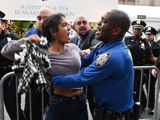 Police tackle pro-Palestinian protesters disrupting the arrivals for the 2024 Met Gala at the Metropolitan Museum of Art on May 6, 2024 in New York. (Photo by ANDREA RENAULT / AFP)