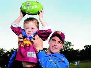 Brisbane Lions captain Jonathan Brown gives a few tips to four-year-old Harrison Bycroft, from Kawana. Picture: Warren Lynam