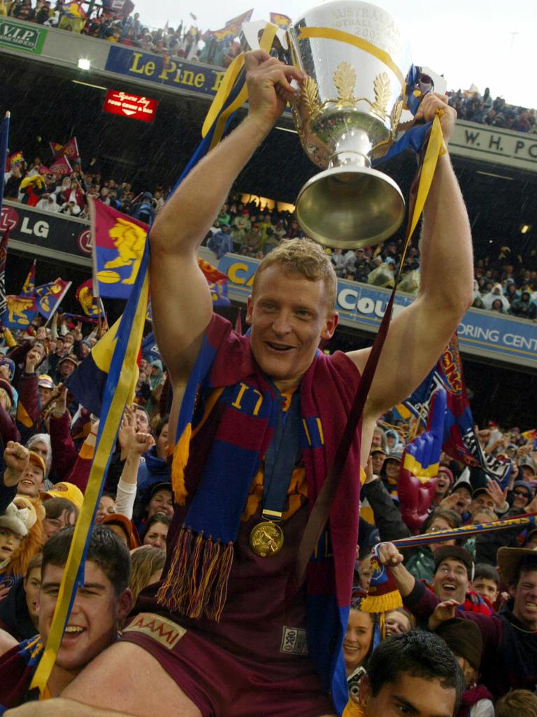 Michael Voss celebrates with the 2002 premiership cup after his team Brisbane beat Collingwood at the MCG. 