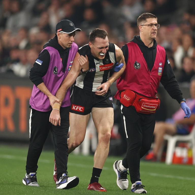 Jack Madgen of the Magpies in the hands of medicos as he heads to the bench during the second quarter. Picture: Michael Klein