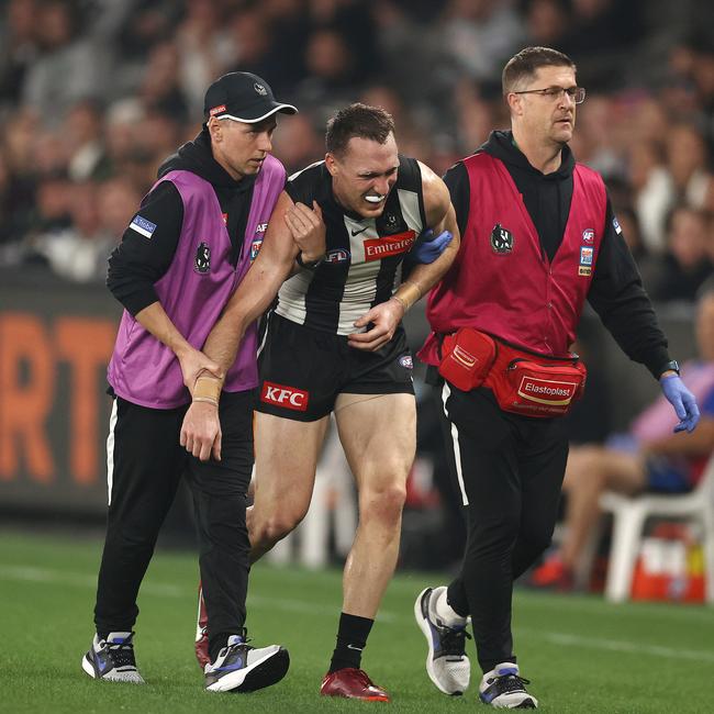 Jack Madgen of the Magpies in the hands of medicos as he heads to the bench during the second quarter. Picture: Michael Klein