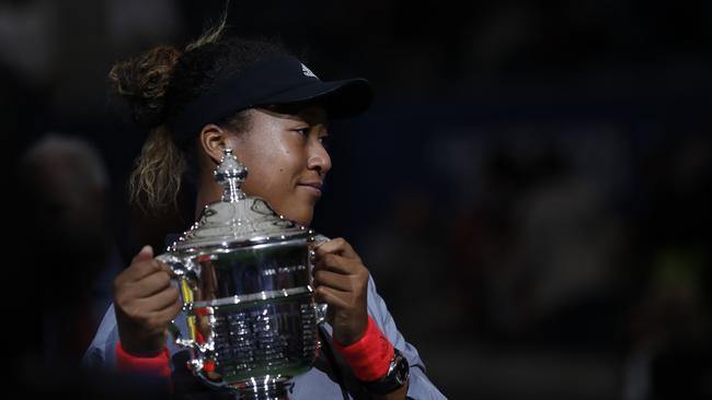 Naomi Osaka, of Japan, holds the trophy after defeating Serena Williams in the women's final of the U.S. Open tennis tournament, Saturday, Sept. 8, 2018, in New York. (AP Photo/Adam Hunger)