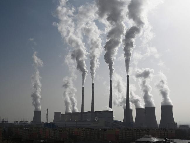 (FILES) This photo taken on November 15, 2021 shows the coal-powered Datang International Zhangjiakou Power Station in Zhangjiakou, one of the host cities for the 2022 Winter Olympic Games, in China's northern Hebei province. As climate envoys from the world's top two greenhouse gas producers meet in Beijing, experts say China's emissions may finally be nearing a peak, though many uncertainties remain. (Photo by GREG BAKER / AFP)