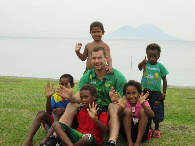 Brenton Lawrence with some local fans in PNG