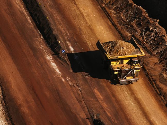 A dumper truck carries excavated iron ore from the iron ore pit at the Sishen open cast mine, operated by Kumba Iron Ore Ltd., an iron ore-producing unit of Anglo American Plc, in Sishen, South Africa, on Tuesday, May 22, 2018. Kumba Iron Ore may diversify into other minerals such as manganese and coal as Africa’s top miner of the raw material seeks opportunities for growth and to shield its business from price swings. Photographer: Waldo Swiegers/Bloomberg