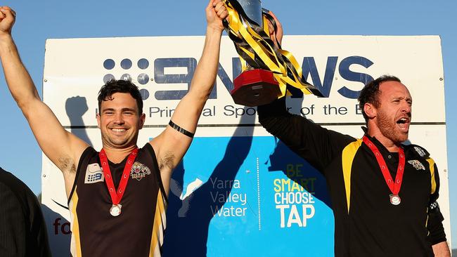 Captain Rennie Gilchrist (left) and coach Daniel Donati hoist the 2012 premiership cup.