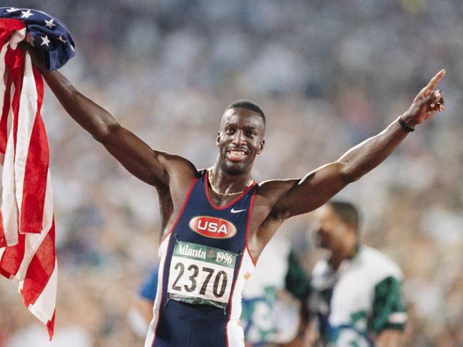 ATLANTA - AUGUST 1:  Michael Johnson of the USA celebrates winning the Men's 200 meter event of the Athletics Competition of the 1996 Summer Olympics on August 1, 1996 in the Centennial Olympic Stadium in Atlanta, Georgia.  (Photo by David Madison/Getty Images)