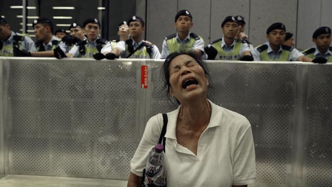 On Monday, a protester was seen reacting to police officers clashing with protesters. Picture: AP/Vincent Yu