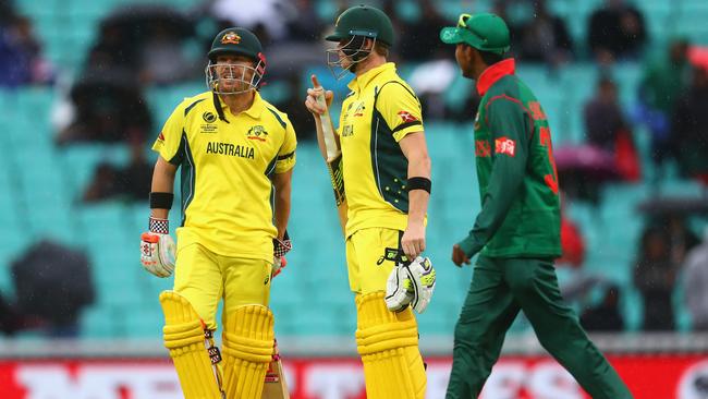 Steve Smith and David Warner look on as play is suspended for rain.