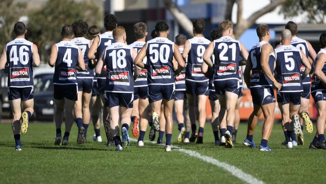 Melton South players warming up. Picture: Andrew Batsch